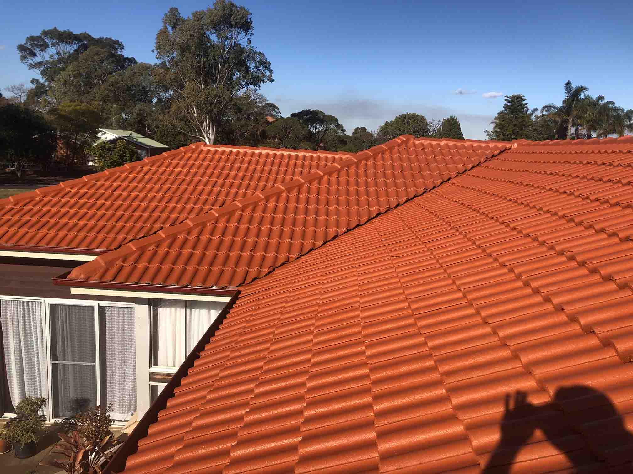 Bright terracotta tiled roof under a blue sky