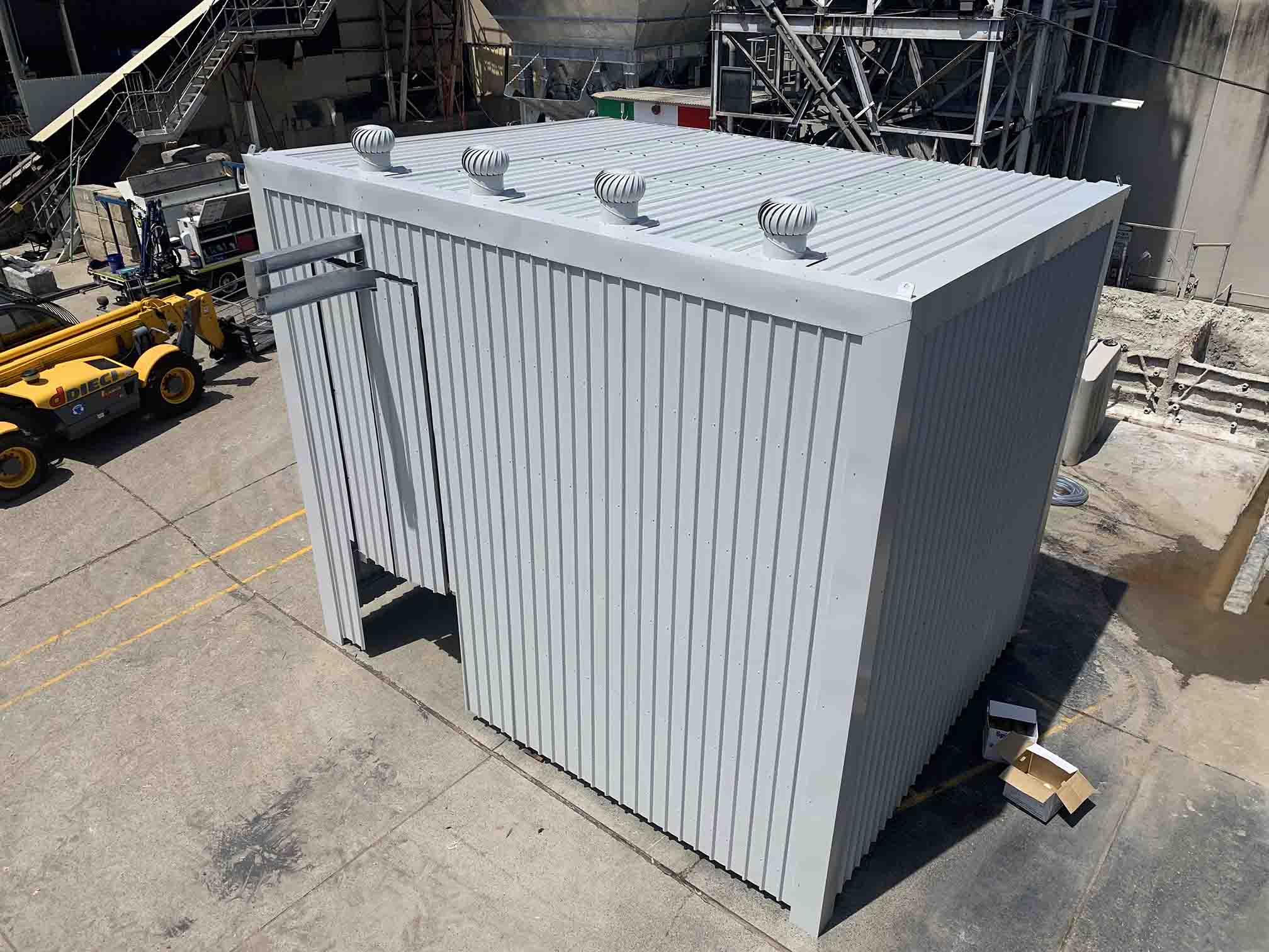 Metal-clad enclosure with four whirlybird vents on its roof